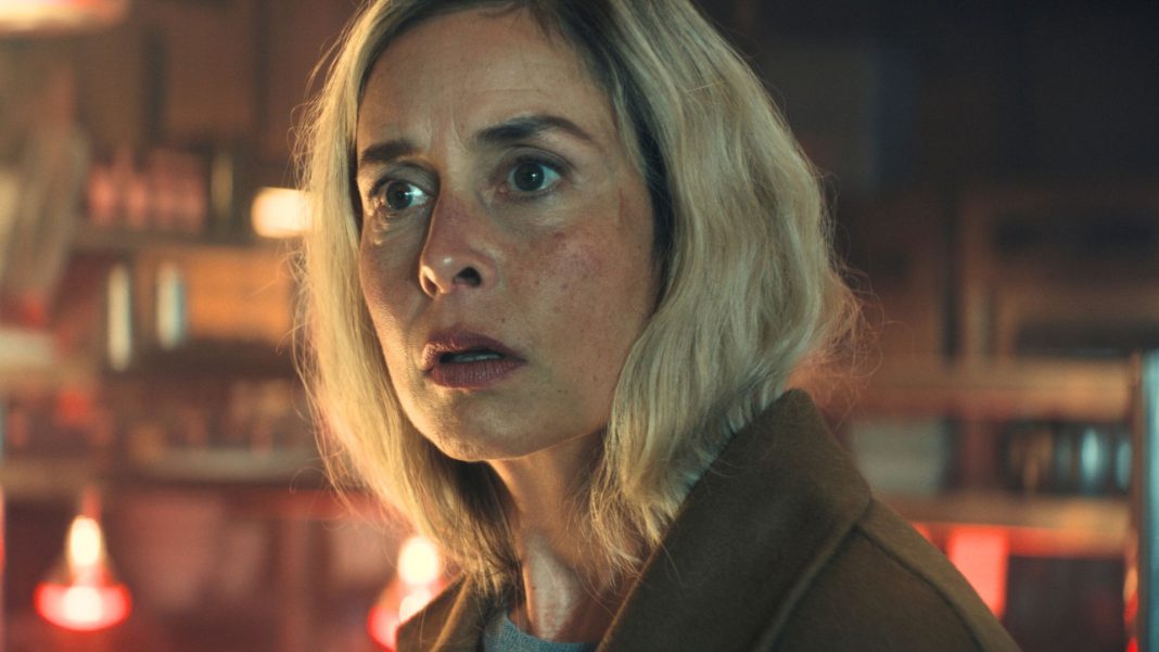 A woman looks shocked at something offscreen