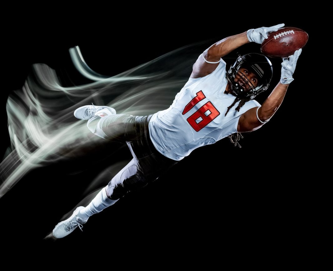 american football player man isolated black background light painting